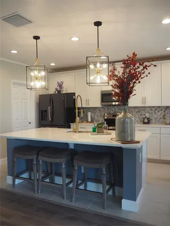 a kitchen with a table and chairs in it