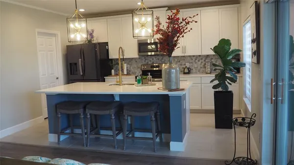 a view of a dining room with furniture and chandelier