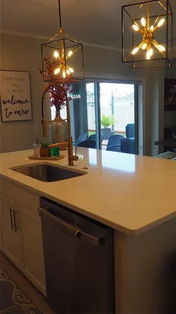 a kitchen with a sink and chandelier
