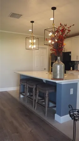 a view of a room with a table and chairs