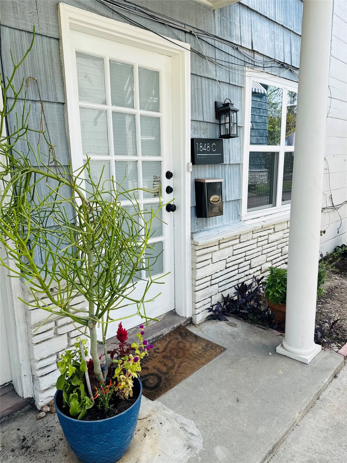 1848 Portsmouth Street, Unit 3 Houston, TX 77098 - Photo 16 of 16 a front view of a house with a potted plant