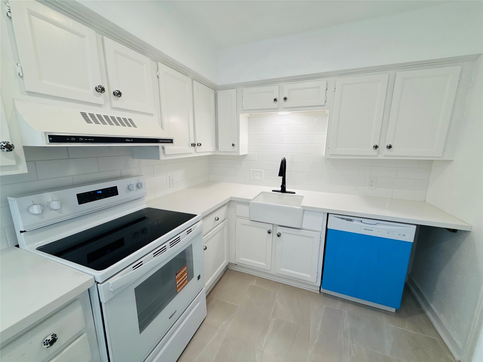 1848 Portsmouth Street, Unit 3 Houston, TX 77098 - Photo 4 of 16 a kitchen with granite countertop white cabinets and white appliances