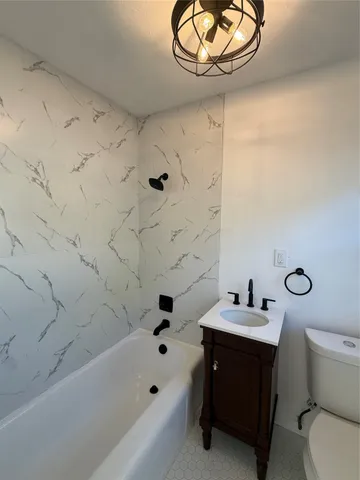 a bathroom with a sink a toilet and bathtub