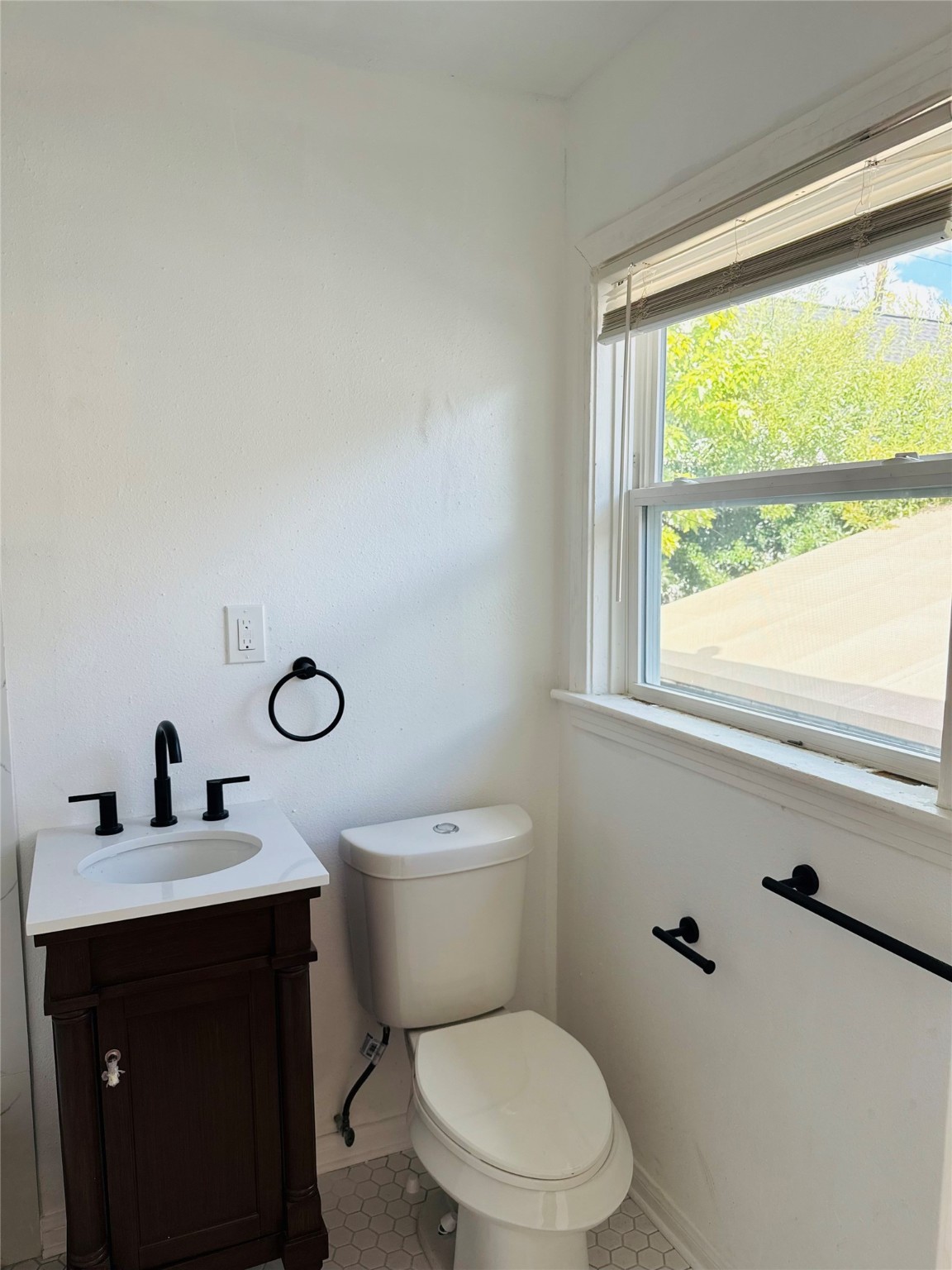 1848 Portsmouth Street, Unit 3 Houston, TX 77098 - Photo 7 of 16 a bathroom with a toilet a sink and a window