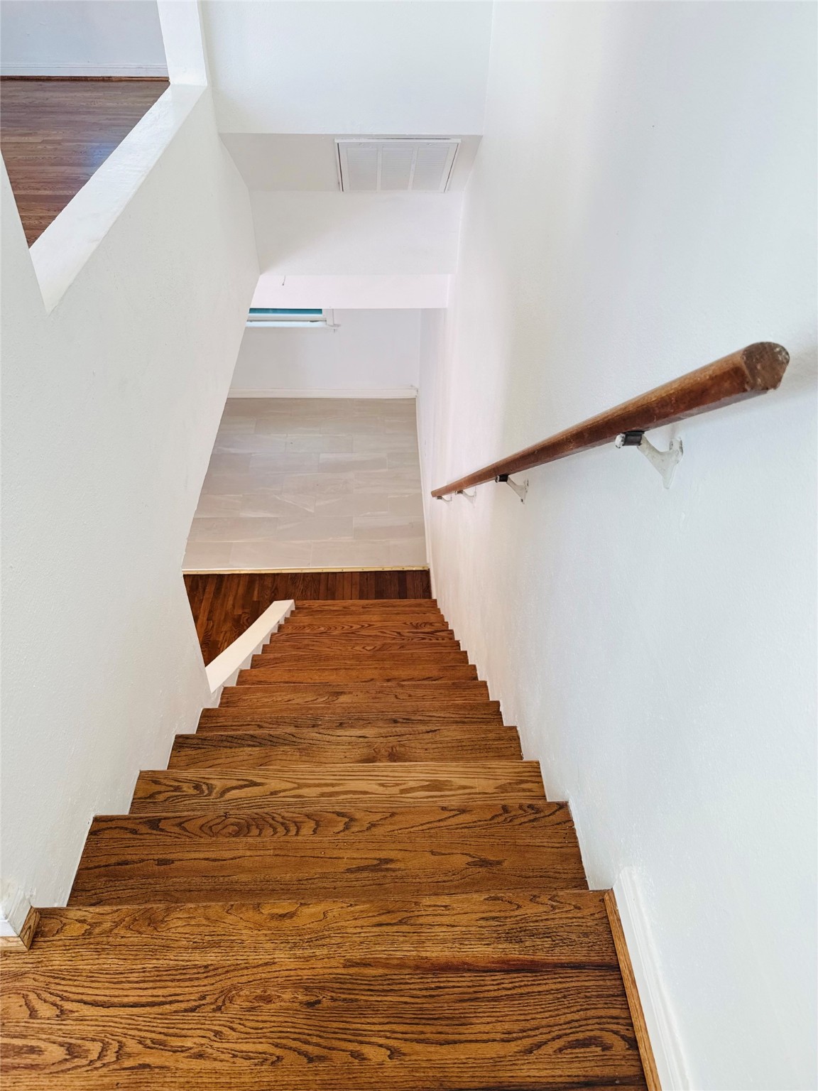 1848 Portsmouth Street, Unit 3 Houston, TX 77098 - Photo 10 of 16 Refinished stairs leading to the upper level, creating a smooth transition between living spaces.