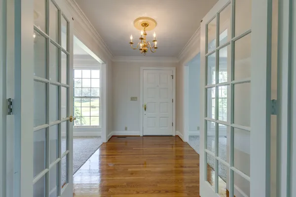 a view of empty room with wooden floor and fireplace
