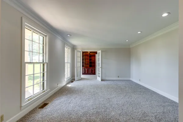 a view of an entryway with wooden floor and a fireplace