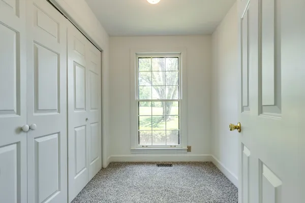 a view of empty room with wooden ceiling