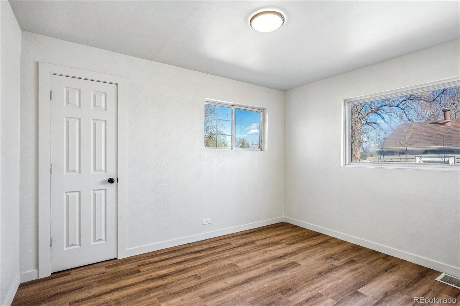802 Julian Street Denver, CO 80204 - Photo 11 of 17 an empty room with wooden floor and window