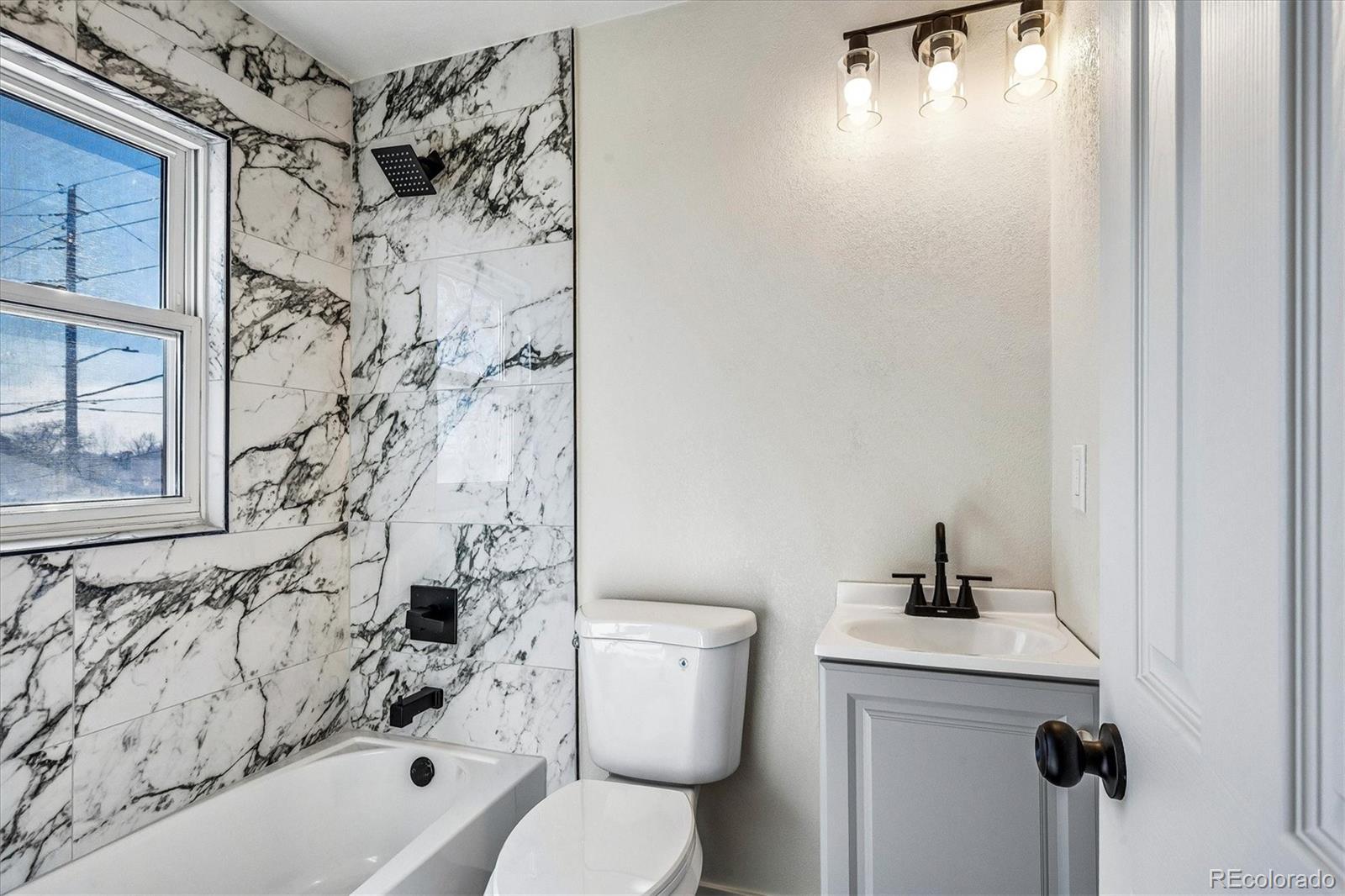 802 Julian Street Denver, CO 80204 - Photo 14 of 17 a bathroom with a toilet and a shower curtain