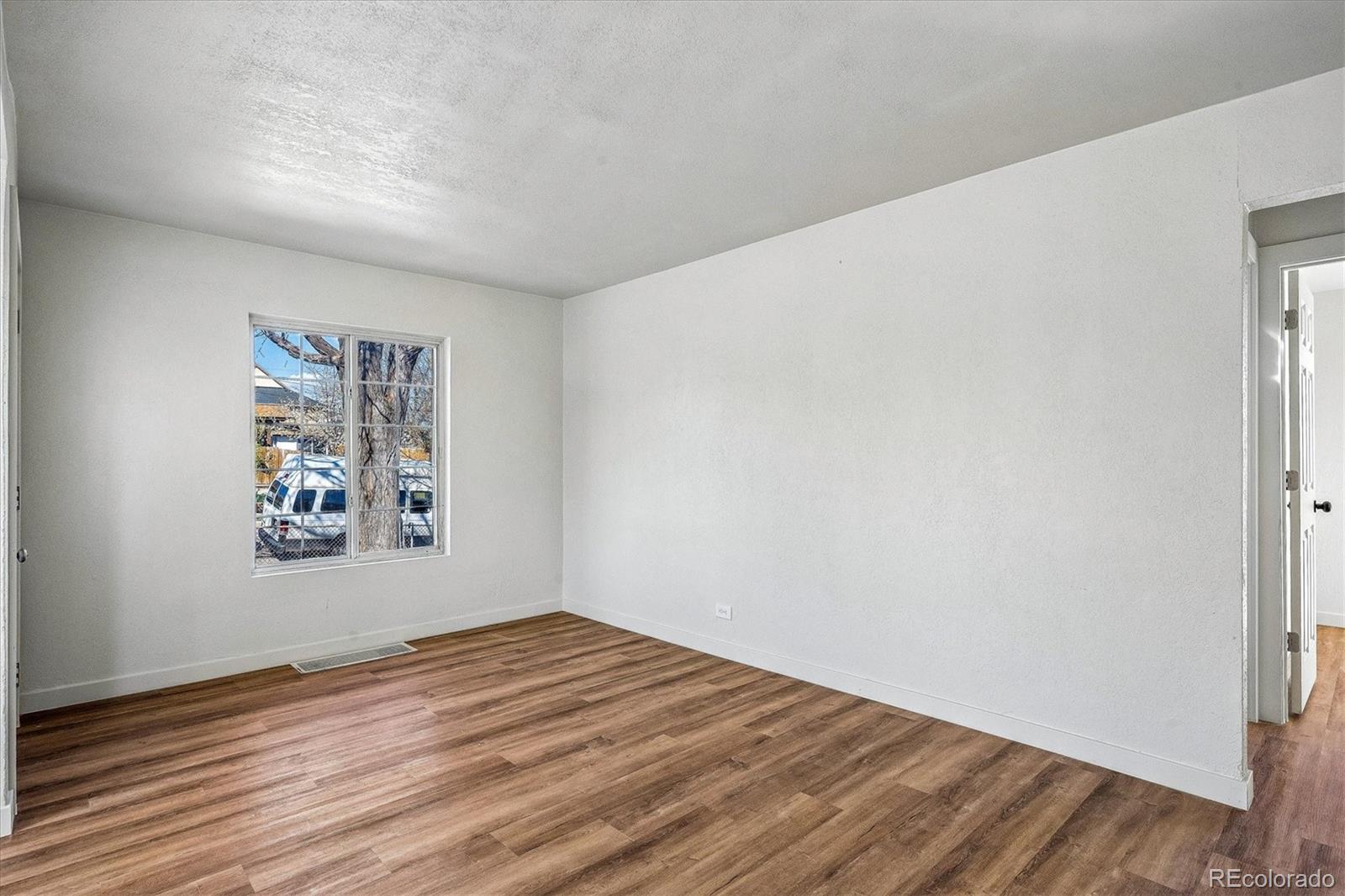 802 Julian Street Denver, CO 80204 - Photo 9 of 17 a view of a big room with wooden floor and windows