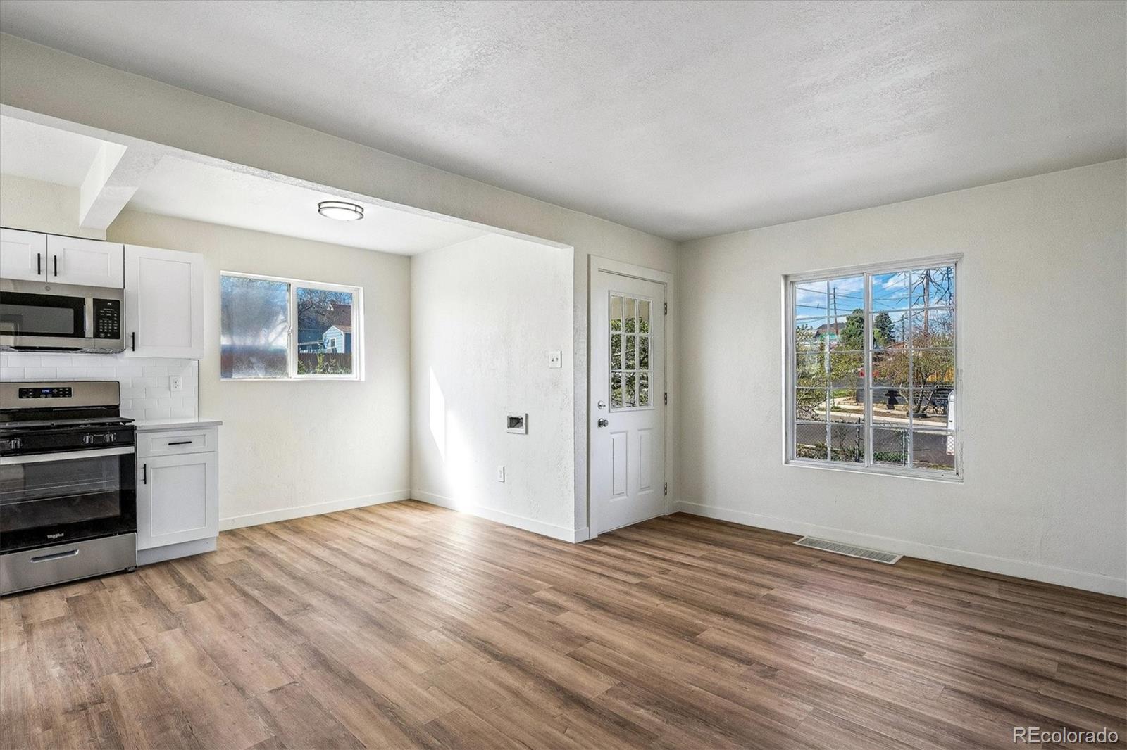 802 Julian Street Denver, CO 80204 - Photo 10 of 17 a view of a kitchen with wooden floor and electronic appliances