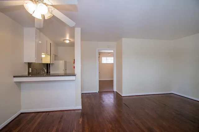 a view of kitchen with granite countertop cabinets and wooden floor