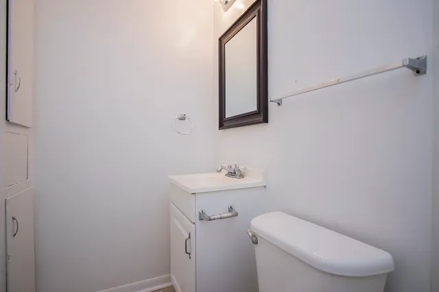 a white toilet sitting next to a bathroom sink