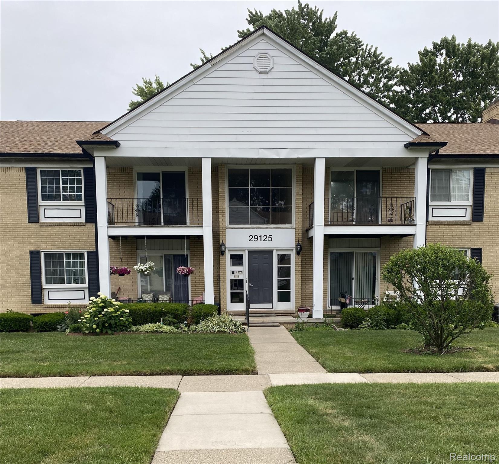 29125 Hayes Road Warren, MI 48088 - Photo 1 of 12 Brick facade building featuring a prominent central gable with white siding