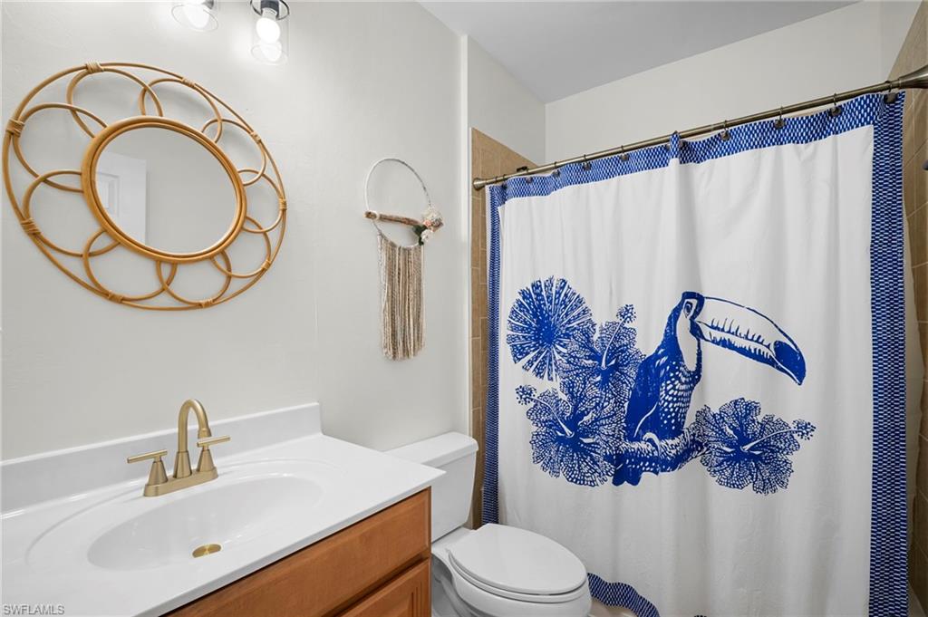 19501 Bowring Park Road, Unit 102 Fort Myers, FL 33967 - Photo 20 of 33 a bathroom with a toilet sink vanity tub and mirror