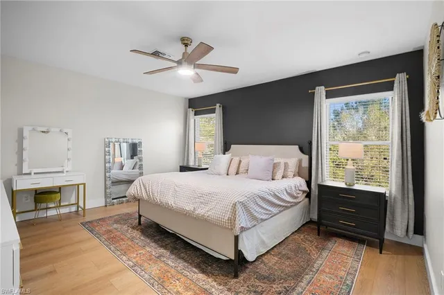 a bedroom with a bed and a ceiling fan