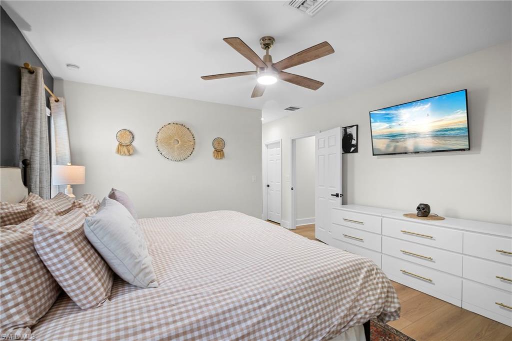 19501 Bowring Park Road, Unit 102 Fort Myers, FL 33967 - Photo 24 of 33 a bedroom with a bed and a flat screen tv