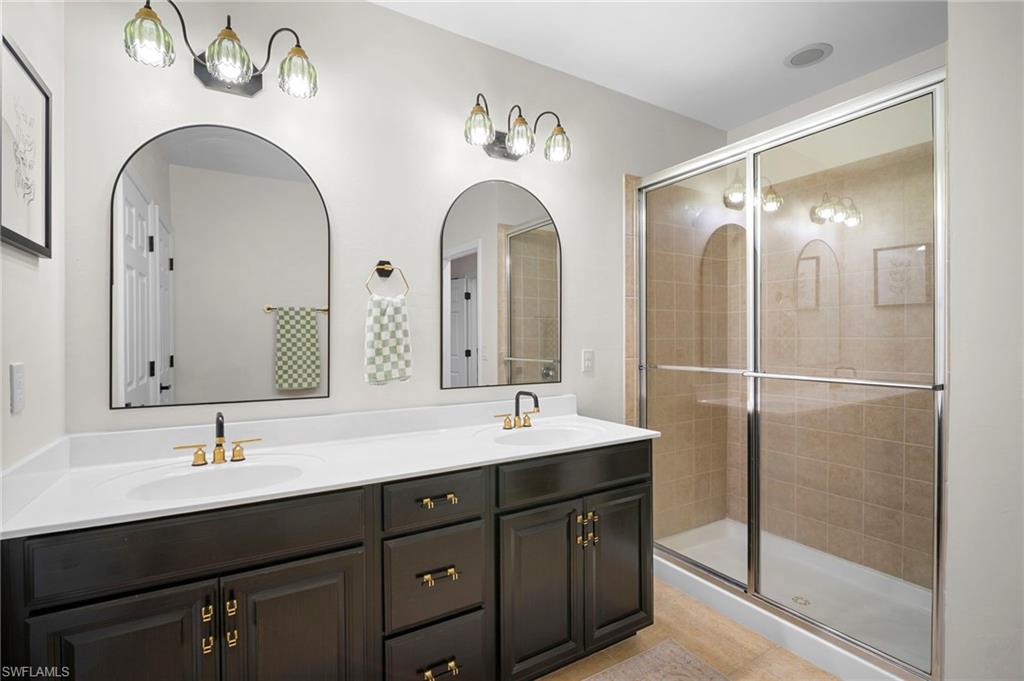 19501 Bowring Park Road, Unit 102 Fort Myers, FL 33967 - Photo 26 of 33 a bathroom with a double vanity sink and mirror