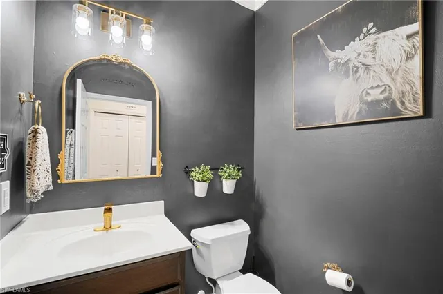 a bathroom with a toilet sink and mirror