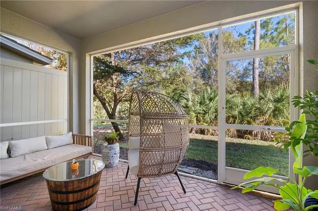 a living room with couch and a swing
