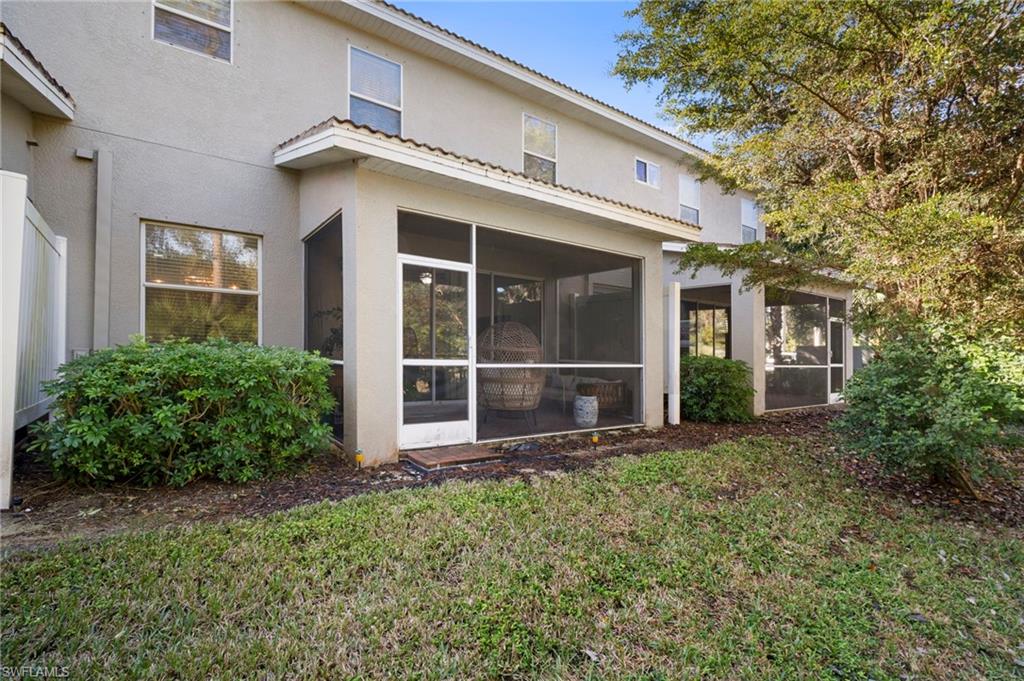 19501 Bowring Park Road, Unit 102 Fort Myers, FL 33967 - Photo 31 of 33 a view of a house with large windows and plants