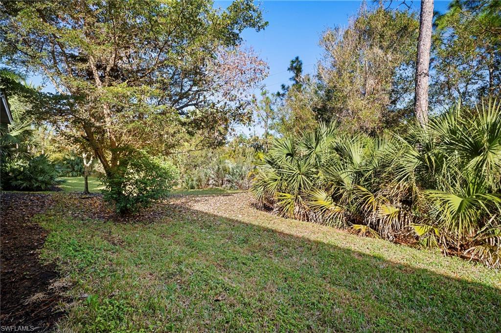 19501 Bowring Park Road, Unit 102 Fort Myers, FL 33967 - Photo 32 of 33 a view of a yard with a tree