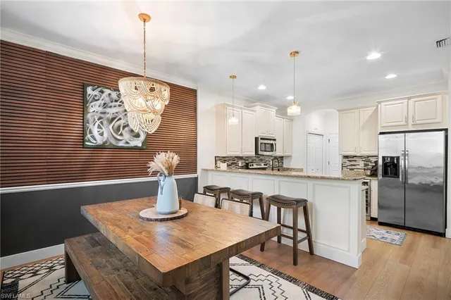 a kitchen with stainless steel appliances granite countertop a sink a stove and refrigerator