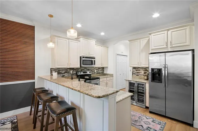 a kitchen with stainless steel appliances a stove a sink island and a refrigerator