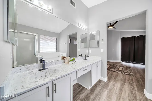 a bathroom with a double vanity sink and a mirror