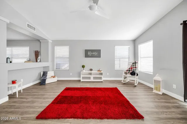 a room with pool table and windows