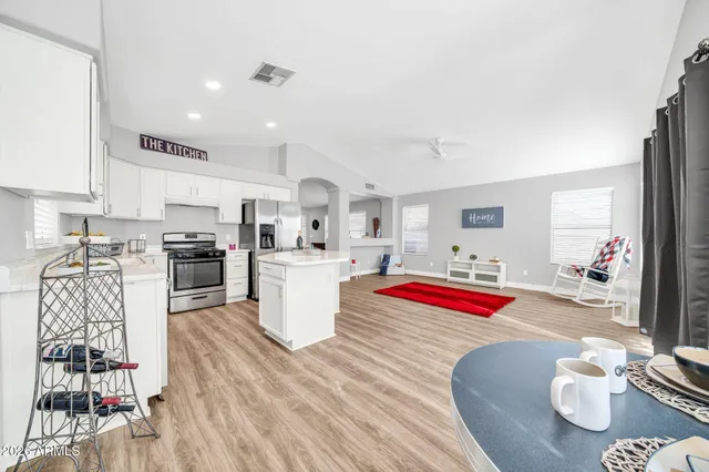 a large bedroom with a bed and a large window