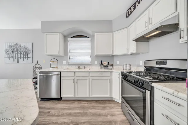 a kitchen with a stove oven and sink