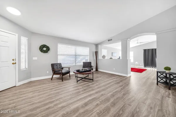 a living room with furniture and wooden floor