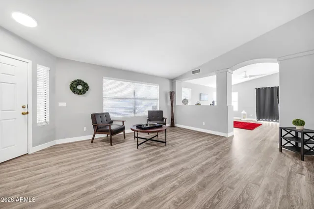 a living room with furniture and wooden floor