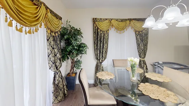 a view of a dinning room with a table and chairs