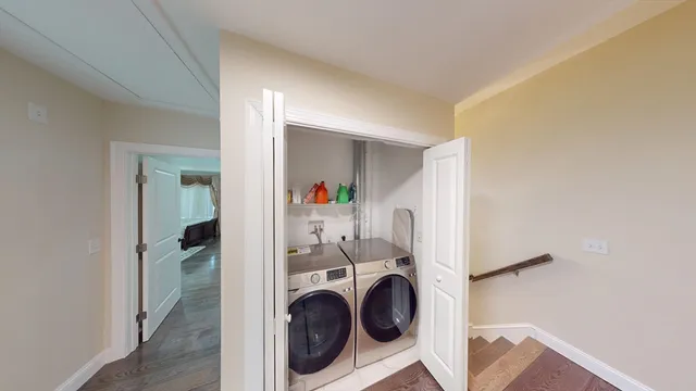 a view of a hallway with washer and dryer