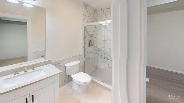 a white toilet sitting next to a bathroom sink