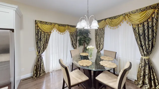 a view of a dining room with furniture wooden floor and chandelier