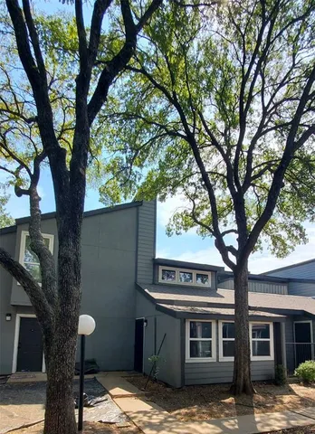 a view of a house with a tree in front