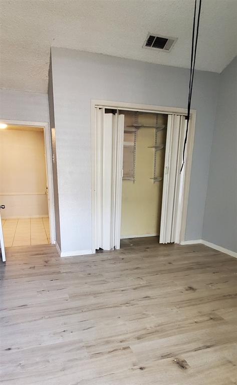 9696 Walnut Street, Unit 106 Dallas, TX 75243 - Photo 12 of 13 a view of an empty room with wooden floor