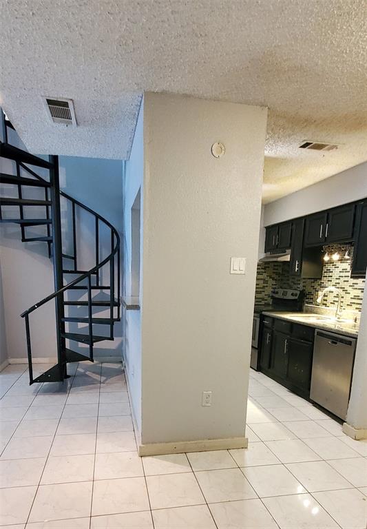 9696 Walnut Street, Unit 106 Dallas, TX 75243 - Photo 4 of 13 a kitchen with stainless steel appliances granite countertop a refrigerator and a stove