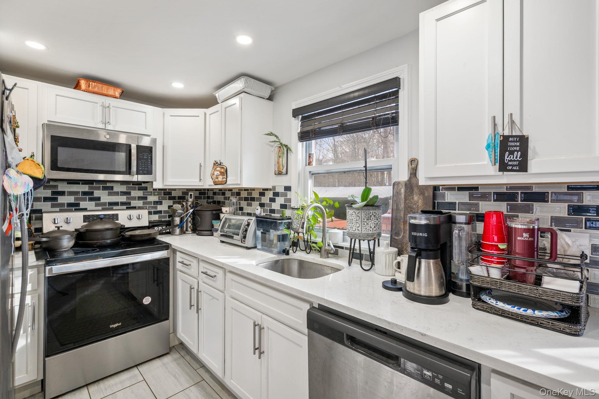 171 High Barney Road Middletown, NY 10940 - Photo 7 of 22 a kitchen with stainless steel appliances a stove a sink and a microwave