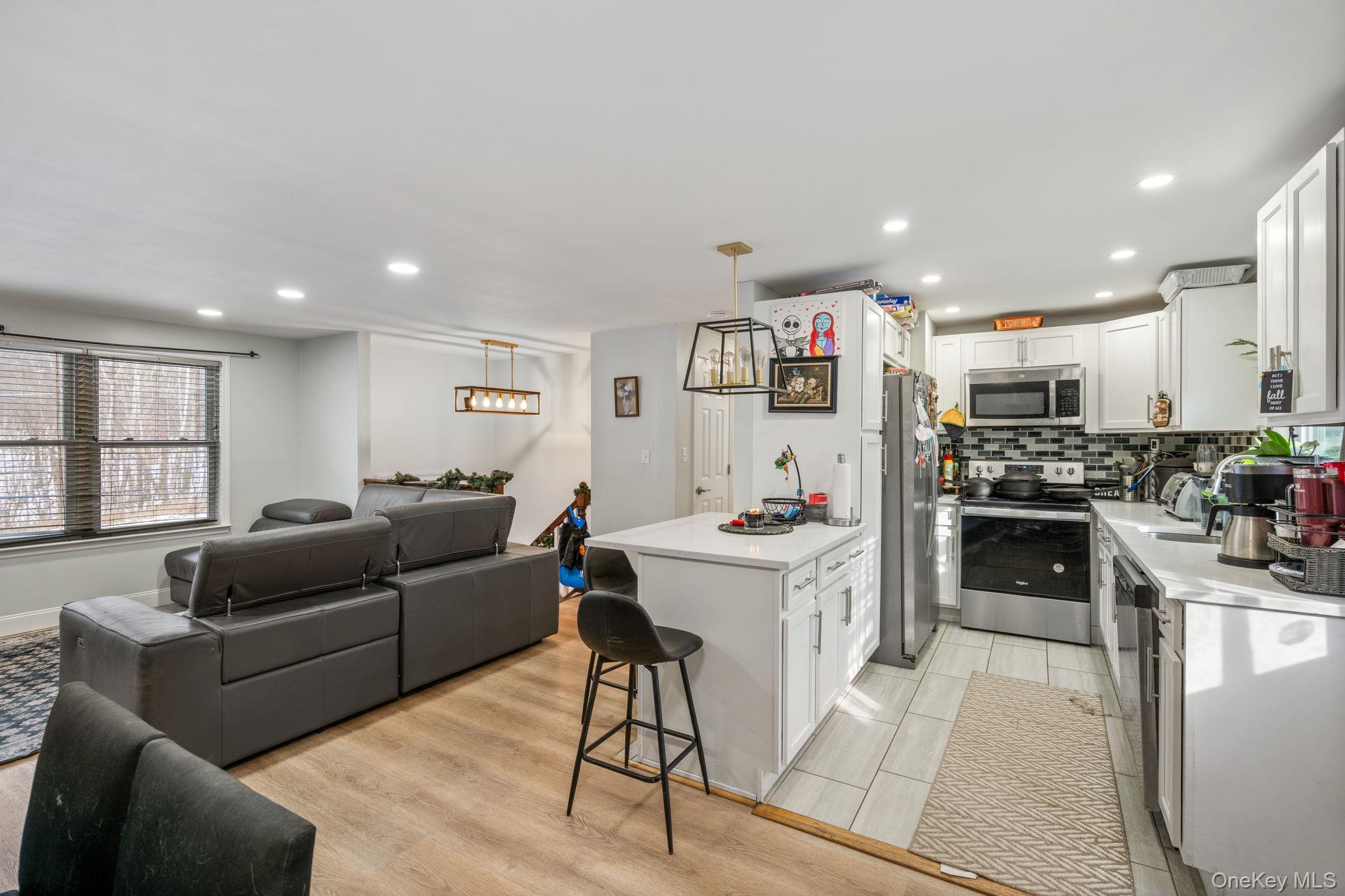 171 High Barney Road Middletown, NY 10940 - Photo 22 of 22 a living room with kitchen island furniture and a kitchen view