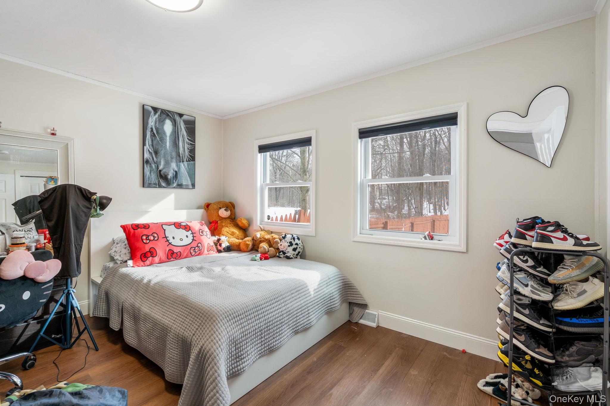 171 High Barney Road Middletown, NY 10940 - Photo 8 of 19 a bedroom with a bed and wooden floor