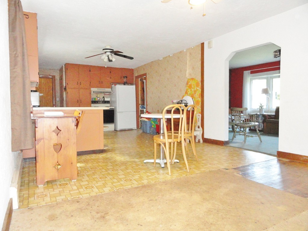 10 Inwood Road Rutland, MA 01543 - Photo 4 of 21 a view of a dining hall with a dining table chairs and a fireplace