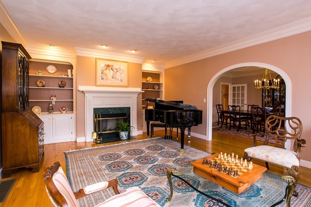 6 Ruggiero Way Andover, MA 01810 - Photo 8 of 30 a living room with furniture a dining table and a fireplace
