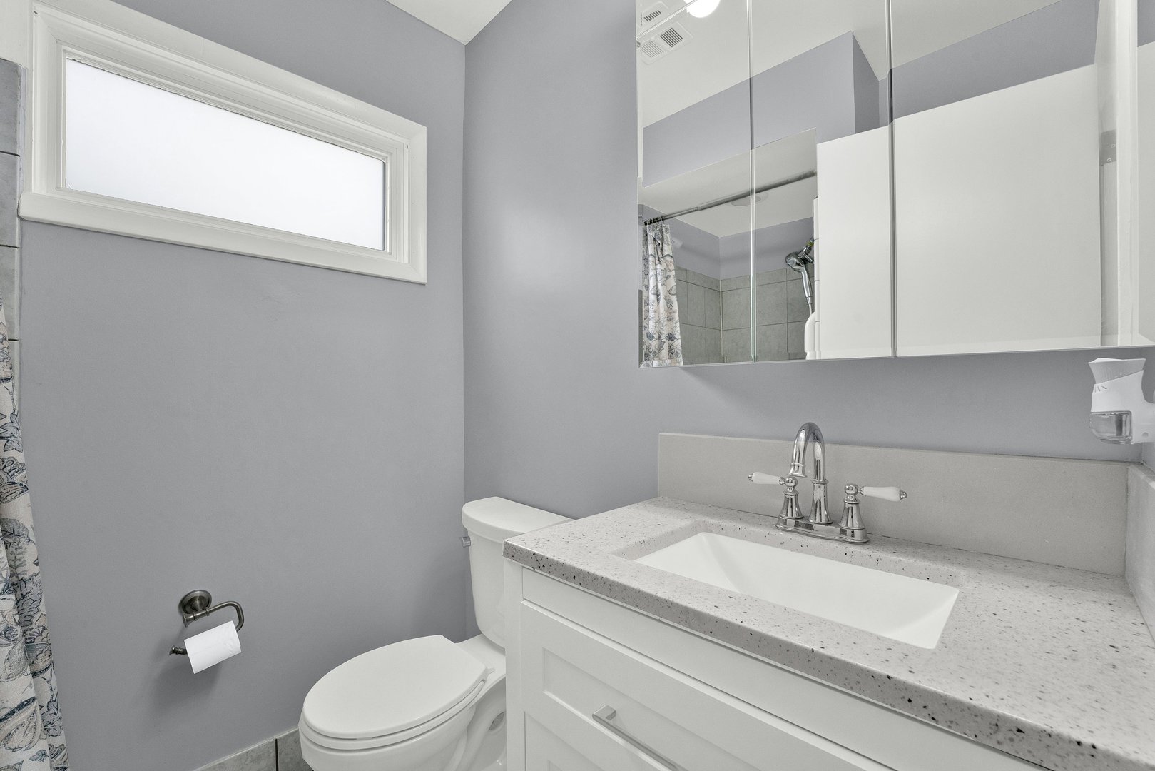 8950 East Prairie Road Evanston, IL 60203 - Photo 15 of 25 a bathroom with a granite countertop sink toilet and mirror