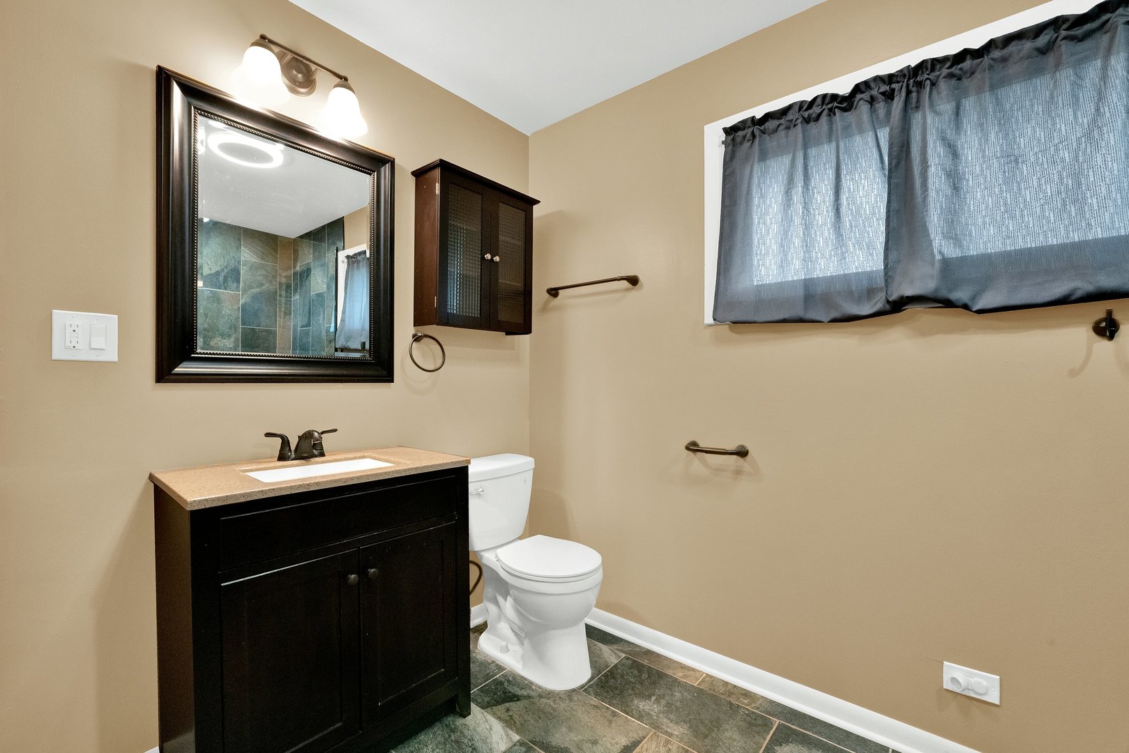 8950 East Prairie Road Evanston, IL 60203 - Photo 17 of 25 a bathroom with a toilet sink and mirror