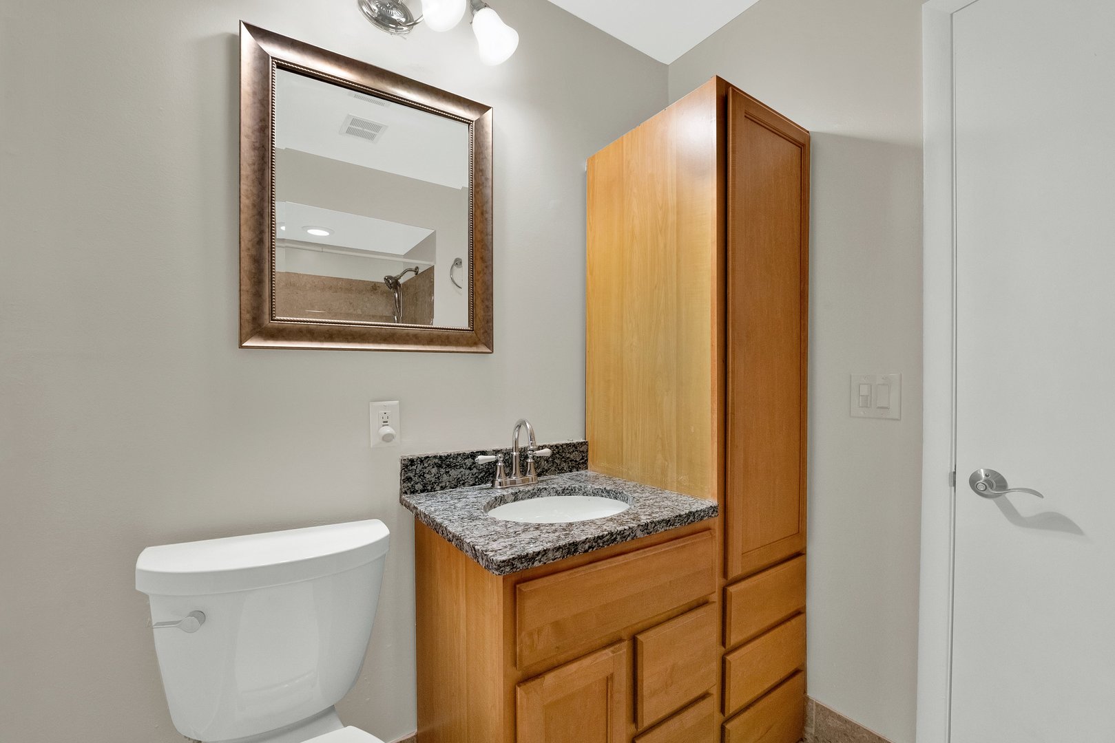 8950 East Prairie Road Evanston, IL 60203 - Photo 21 of 25 a bathroom with a granite countertop sink and a mirror